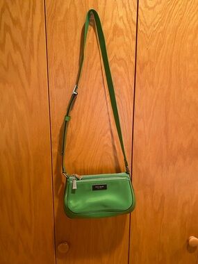Nylon and stiff leather cross body bag, with adjustable strap.
10” x 6” x 4 1/2”